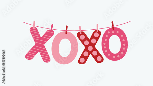 Hanging letters spelling xoxo on a pink string with colorful patterns and clips