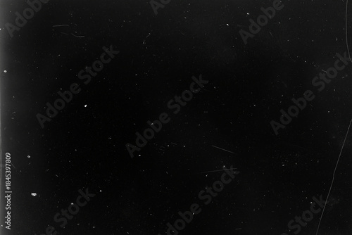 Deep dark vintage photo background, almost pure black with subtle vignette, dust specks and faint scratches, analog film grain texture with empty copy space for text, poster, overlay, cinematic 