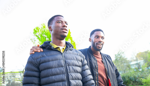 African American friends enjoying wellness and connection on a spring walk in the park.