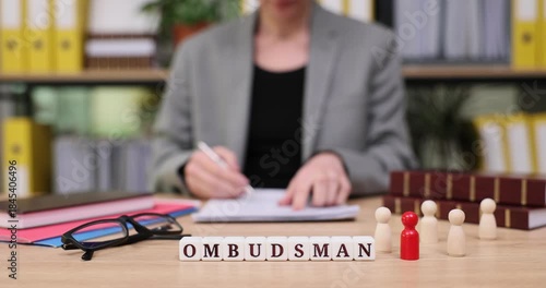 Office work showcase highlighting an ombudsman reviewing cases with colorful figures in an organized environment