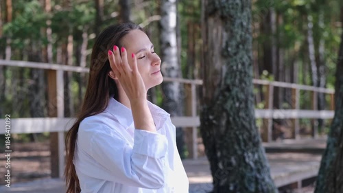 Young woman standing at balcony and watching sunset