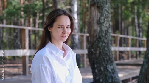 Young woman standing at balcony and watching sunset
