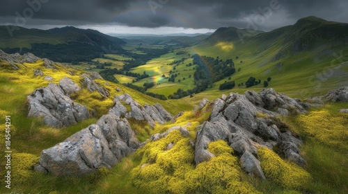 Dramatic Rainbow Over a Rocky Valley and Green Slopes