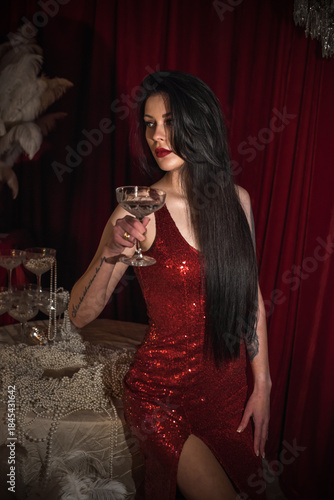 Passion brunette woman in shining red fashionable dress in vintage interior