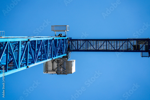 Canvas Print Blue crane against a beautiful blue sky, as seen from below, worms eye view