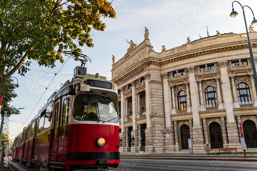Red Tram Passing Historic European Opera House