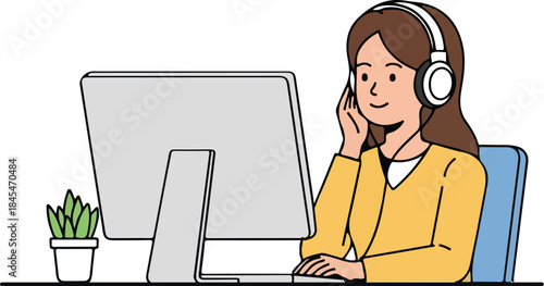 Female customer service representative wearing headphones working at computer screen typing with small potted succulent plant on desk remote work concept online