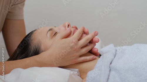 A woman is laying on a bed with her head resting on a pillow