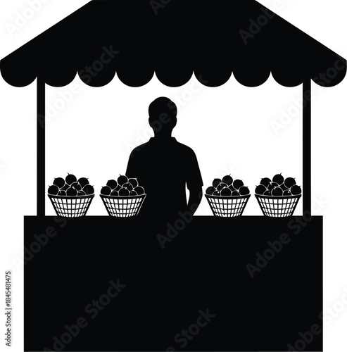 Fruit vendor standing behind market stall