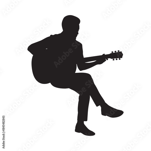 A silhouetted musician playing an acoustic guitar seated in a relaxed posture