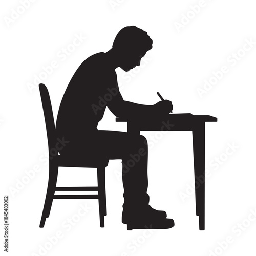 Silhouette of a person seated at a desk writing with a pen
