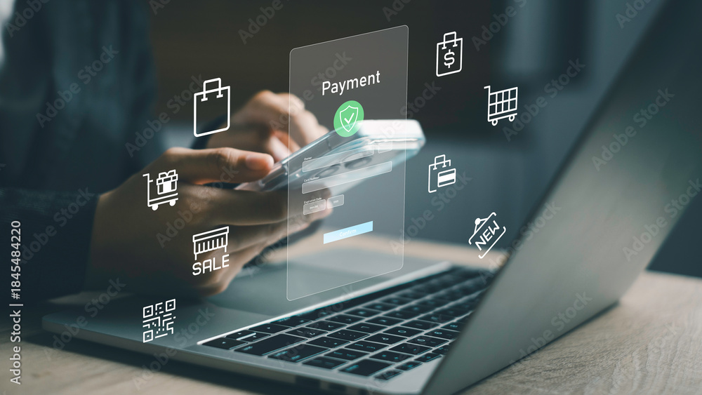 Fototapeta premium Person making secure online payment via smartphone and laptop, surrounded by shopping icons. Illustrates e-commerce, digital transaction, and mobile shopping experience.