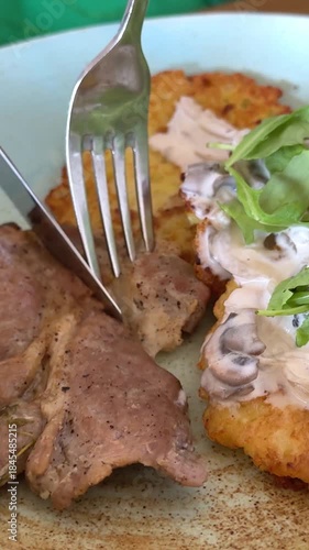 cutting steak on a plate lunch dinner vegetable vegetarian fried cabbage pancakes in the pan. High quality 4k footage