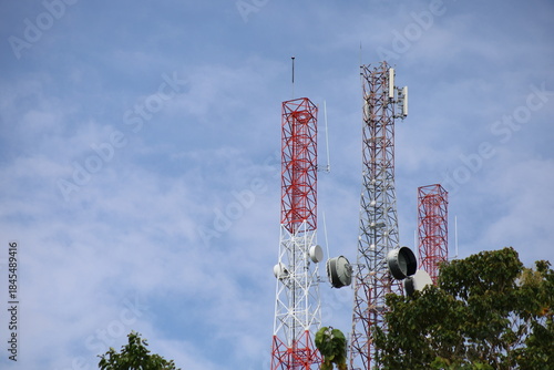 Tower crane and communication antenna on a steel structure construction site against a blue sky, representing wireless telecommunication network technology and the building industry