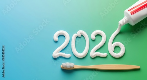 2026 New Year number written with white toothpaste on green background with toothbrush, dental care concept.