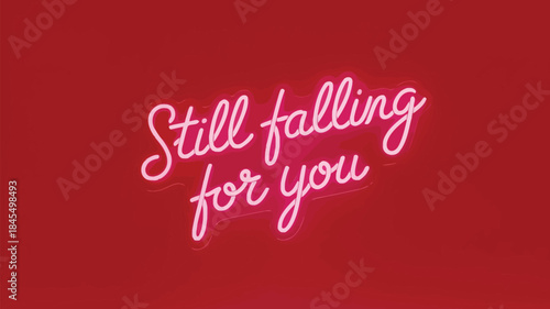 A neon sign style text display reading still falling for you on a red background with pink lighting
