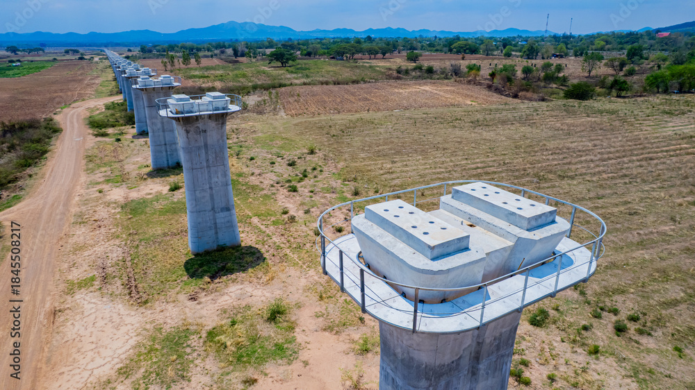 Naklejka premium The concrete pillars/piers for the high-speed rail track are under construction at the unfinished construction site.