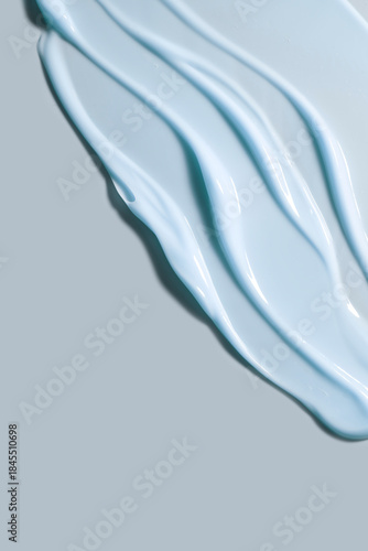 Light blue cosmetic cream texture swatch. Smooth lotion or gel skincare beauty background with product wave stroke and smear abstract