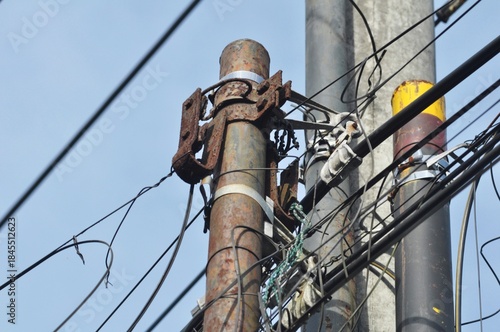Old Power Pole Infrastructure with Chaotic Cable Lines