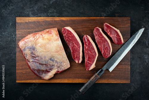 Photos Raw dry aged wagyu Brazilian picanha steaks from the sirloin cap of rump beef sl