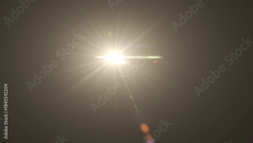 Optical lens flare with warm bokeh effects, golden sunbeam shining brightly, dark background