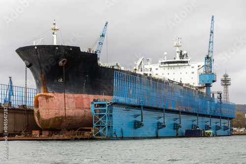 Wallpaper Mural A massive tanker vessel with a bulbous bowin in dry dock for maintenance at a commercial shipyard. Shipbuilding, Repair and Maritime industry concept. Torontodigital.ca