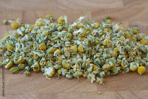 A Close-Up of Dried Chamomile Flowers Arranged on a Wooden Surface, Highlighting Their Unique Shape, Color, and Texture for Herbal Use
