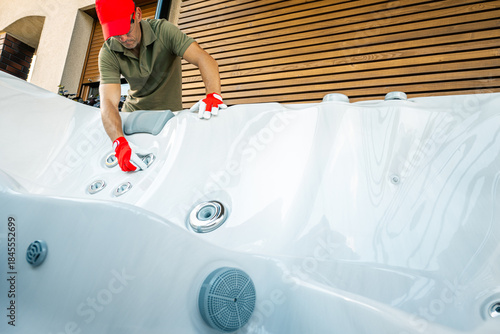 Man Cleans Hot Tub at a Home in Bright Afternoon Light