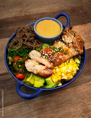 Grilled chicken salad with fresh vegetables and pasta.