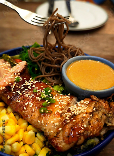 Grilled chicken salad with fresh vegetables and pasta.