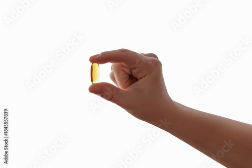 Vimamin D3 Omega Capsule for Children. Omega-3 d3 in Child Hand Isolated on White Background. Kids Immune System. 