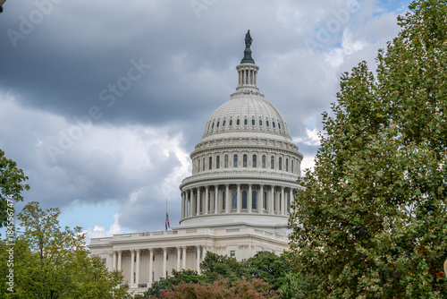 U.S. Capitol Dome Framed by Trees Under Cloudy Sky