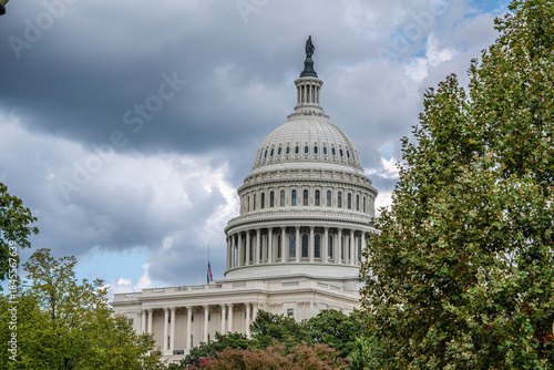 U.S. Capitol Dome Framed by Trees Under Cloudy Sky