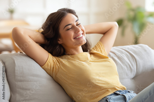 Free Download Happy woman relaxing on the sofa at home Smiling girl enjoying day off lying on the couch, Healthy life style, good vibes people and new home concept - GFXLoad
