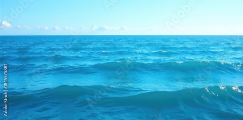 Fototapeta Naklejka Na Ścianę i Meble -  Deep blue ocean with small, rhythmic waves under a clear sky, blue, day