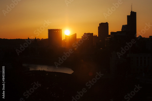 A warm summer sunset over Vilnius, the capital of Lithuania. The view from Gediminas Tower of the modern monolithic buildings on the right bank of the Neris River.