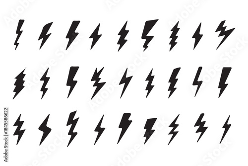 This image displays a collection of approximately 30 black lightning bolt symbols arranged in three rows on a plain white background. The icons vary in style, showcasing different thicknesses, jaggedn