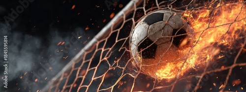 an intense moment of a soccer ball being struck by a kick, set against a background that resembles a fiery soccer field with a net in the background