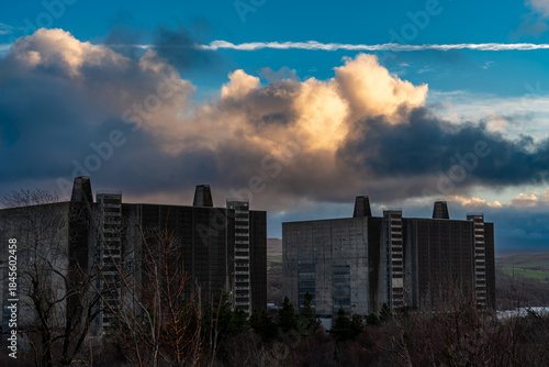 Trawsfynydd Nuclear Power Station at sunrise, showing decommissioned reactor buildings under low cloud and early light