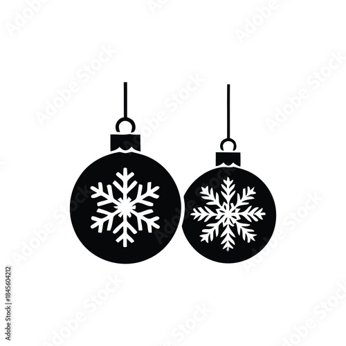 Pair of festive black Christmas ornaments with white snowflake designs