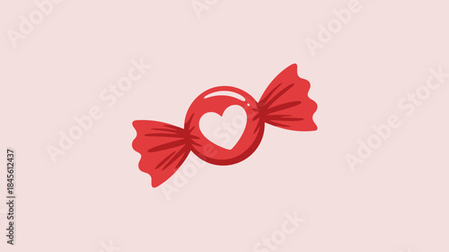 A vibrant red heart shaped candy wrapped in crimson colored paper on soft pink background sweet treat for valentine's day