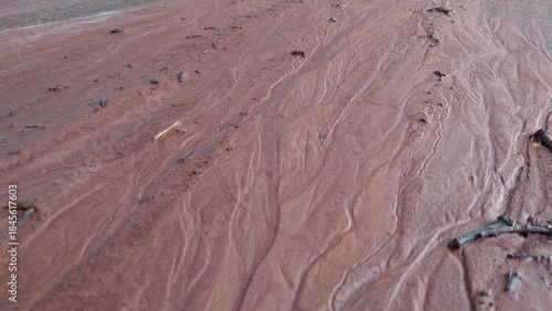 Mud drifts and rivulets on the ground Texture of wet silt and mud with traces of water erosion