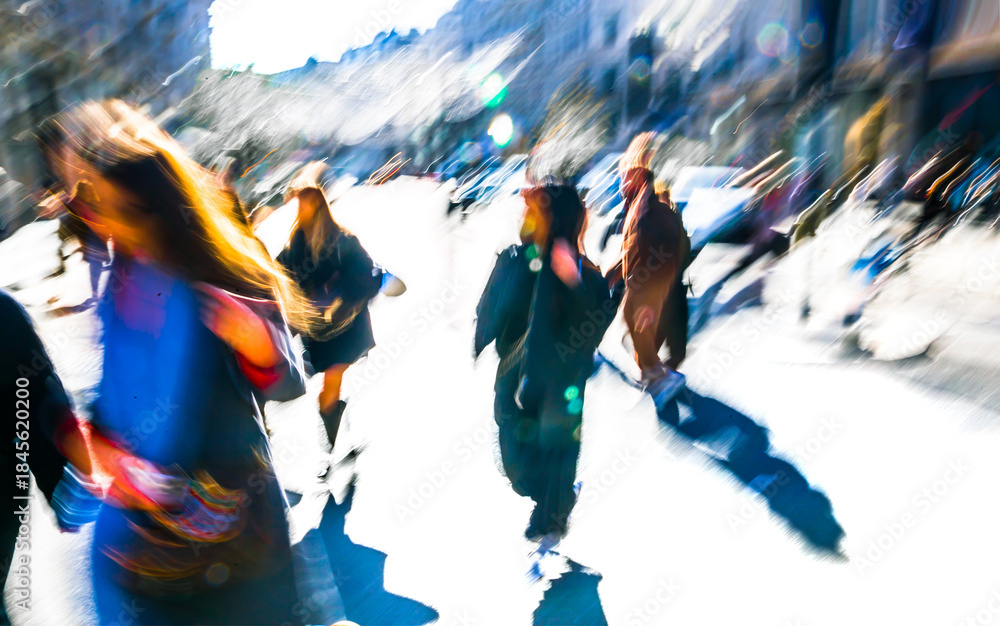 Fototapeta premium Postmodernism style, artistic motion of people with shopping bags crossing Oxford Circus junction at sunny day. London