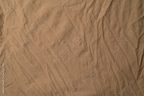 Close-up of light brown fold plain fabric.Light brown fold plain fabric texture and background.