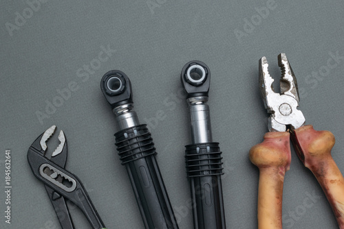 Vászonkép Assorted Heavy-Duty Hand Tools on a Gray Surface: Pliers, Wrenches, and Socket W