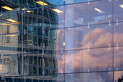 Modern architecture reflection on glass facade of urban office building with abstract pattern design creating dynamic contemporary city background