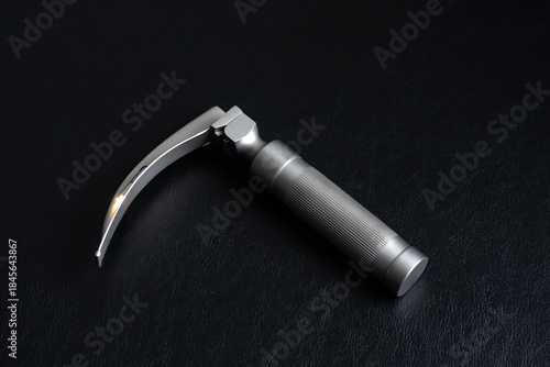 Laryngoscope on a dark background. Horizontal shot.