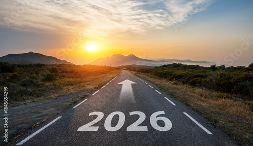 New year 2026 or start straight and beginning concept. Man ride on bike and the number 2026 start written on the road at sunset with lens flare. Concept of challenge or career path, business strategy.