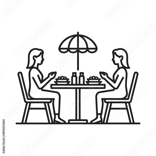 Outdoor dining scene with two people enjoying a meal at a table