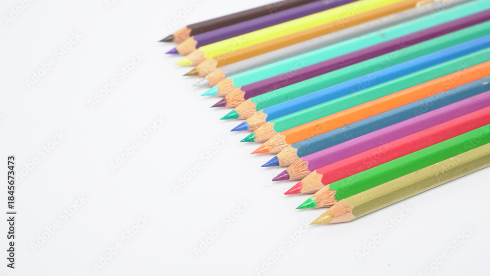 Fototapeta premium A collection of colorful drawing pencils on a clean white surface for art and education.